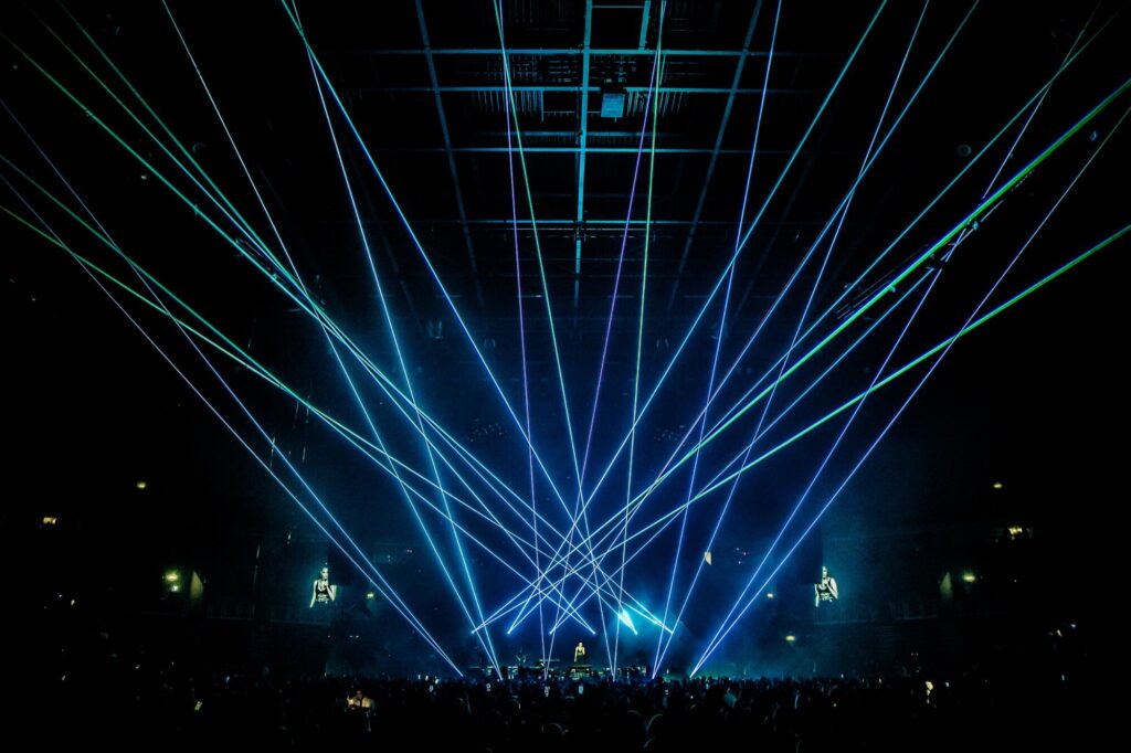 Sharp aerial laser beams cutting through festival haze at Sea Star, Umag